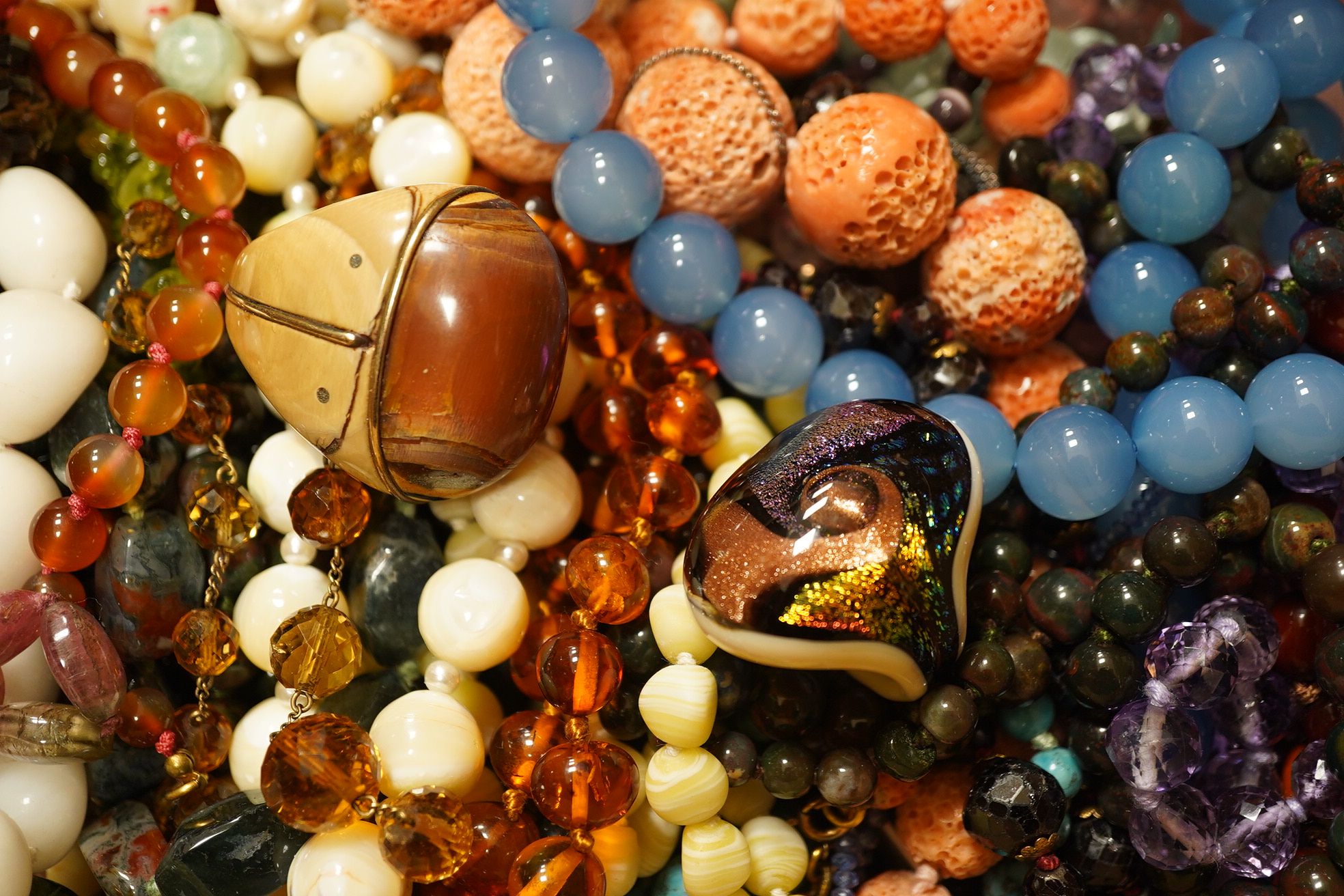 A quantity of assorted bead necklaces including, coral, various agates, turquoise cat's eye quartz, rock crystal, tiger's eye quartz, amethyst, aquamarine etc. Condition - poor to fair to good